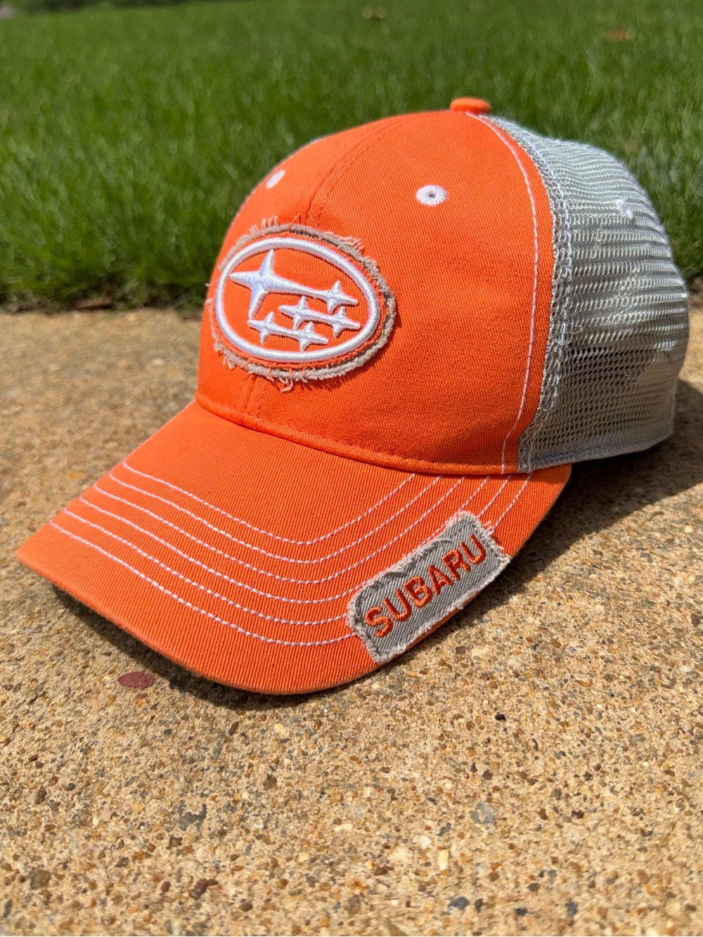 Subaru Orange and tan trucker hat. embroidered logo baseball